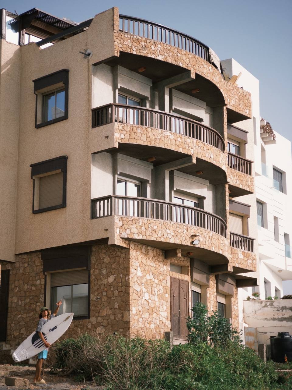 Tazurf building with surfer Mirleft Morocco