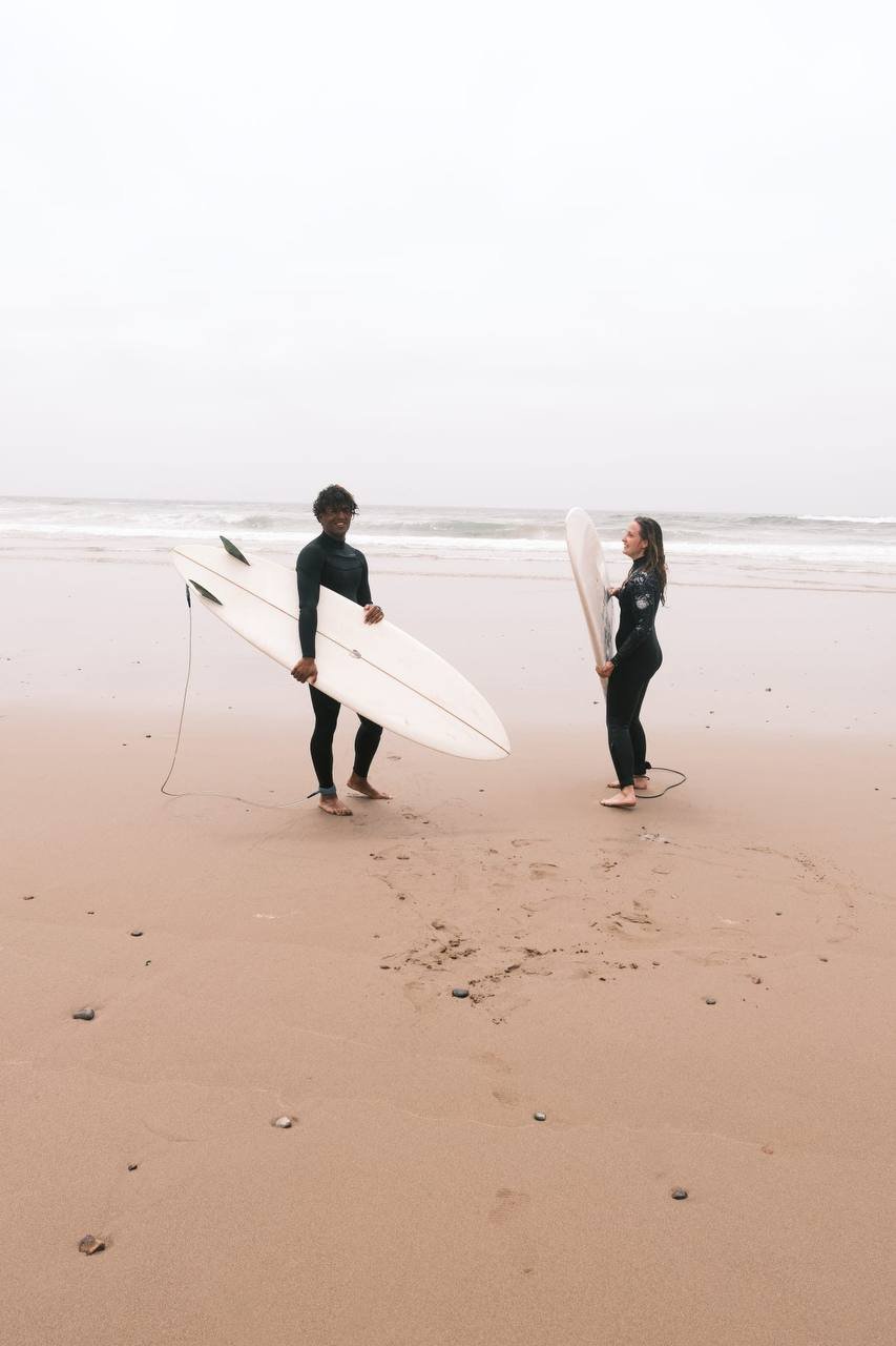 Surfers with boards on the beach