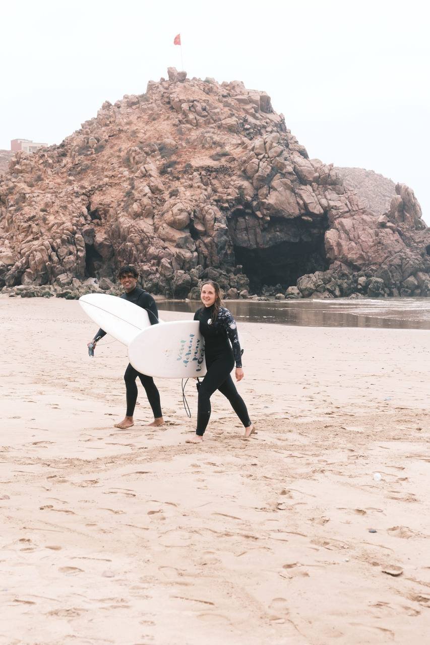 Surfers walking on Mirleft beach with boards