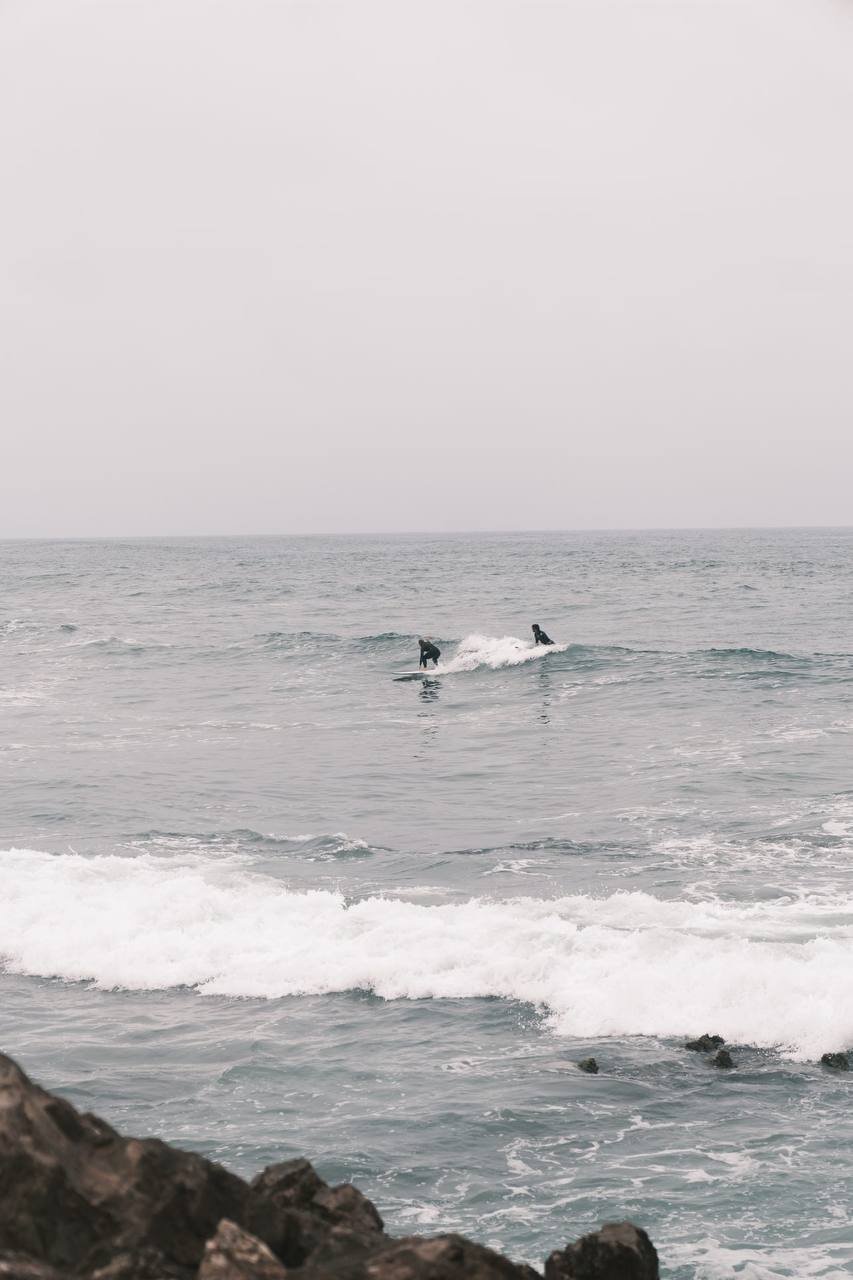 Surfers catching waves off Mirleft